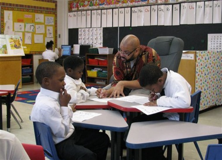 Teacher Calvin Hobbs works with students at African-centered Timbuktu Academy of Science and Technology in Detroit on March 15. Timbuktu has about 350 students and is one of nine Detroit Public Schools-authorized charter schools. 